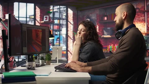 Two developers team interact with virtual AI assistant on PC Stock Footage 308674380