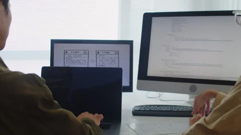 Two Developers Testing New Code on Digital Devices Stock Footage 256976002