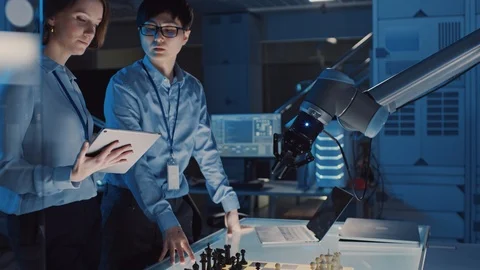Two Development Engineers are Discussing and Testing an Artificial Intelligence Stock Footage 105349390