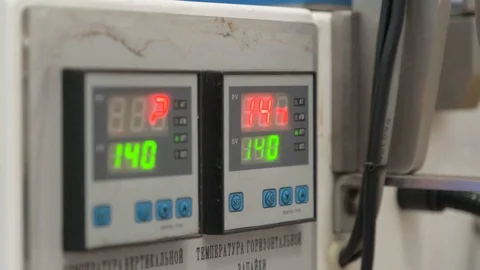 Two devices show measurements. Electronic scoreboard. Red and green numbers. Stock-Footage 127777553