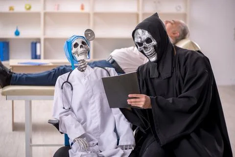 Two devil doctors examining old male patient Stock Photos