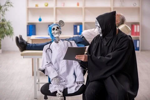 Two devil doctors examining old male patient Foto stock