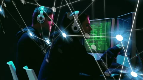 Two devs coding and pointing monitors, causing overlay to map heads and hands Stock Footage 334884126