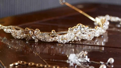 Two diamond rings on a wooden table, surrounded by beautiful jewelry 스톡 동영상 320448622