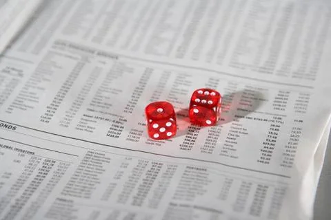 Two dice on a newspaper Stock Photos