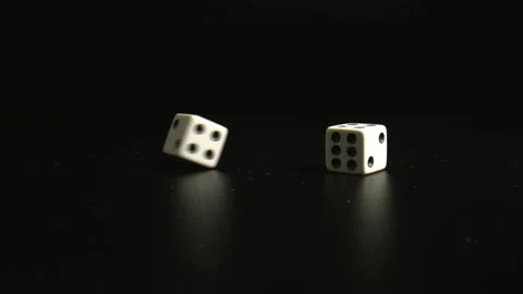Two dices falling on black table close up. Entertainment Game Concept. Close-up Stock Footage 144341764