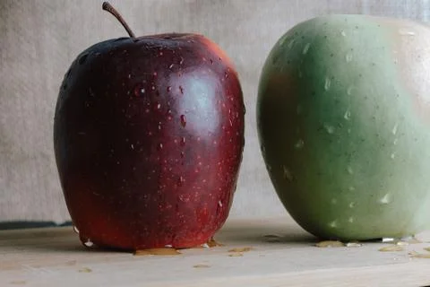 Two different apples on slate and rustic background Stock Photos