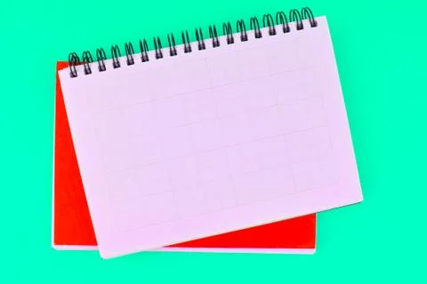 Two different colored note paper diary placed on top of each other on a blue Stock Photos