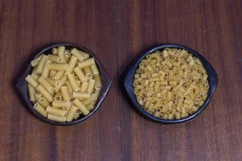 Two different containers with two different types of edible pasta Stock Photos