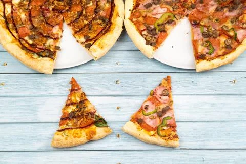 Two different delicious big pizzas on a blue wooden background Fotos Stock
