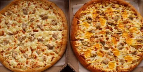 Two different delicious pizzas in open boxes Stock Photos
