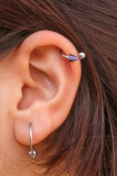 Two different earrings at  lady ear Stock Photos
