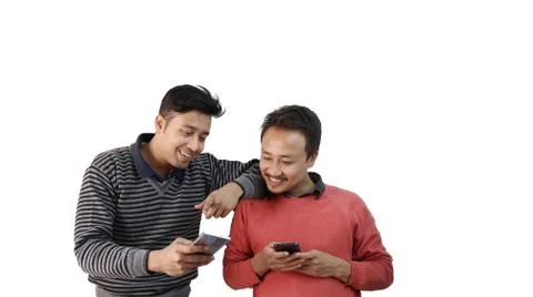 Two different ethnic men talking and smiling with mobile phone in hand isolated Stock Photos