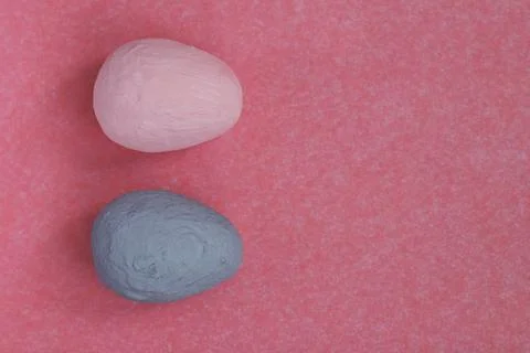 Two different graphic painted eggs on a trendy background of corals. 写真素材