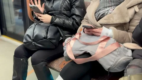 Two different individuals were actively engaged with their smartphones while 스톡 동영상 316463147