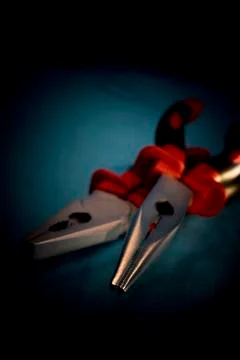 Two different pliers in a dark environment Stock Photos