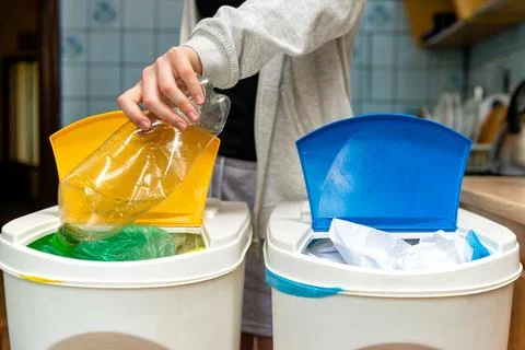 Two different recycling bins with yellow and blue lids 스톡 사진