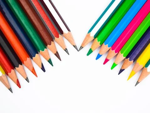 Two different row of different colored wood pencil crayons with one beside an Foto stock