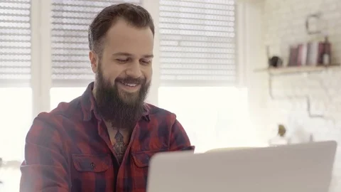Two different shots of a hipster guy spending time with his laptop Stock Footage 72513339
