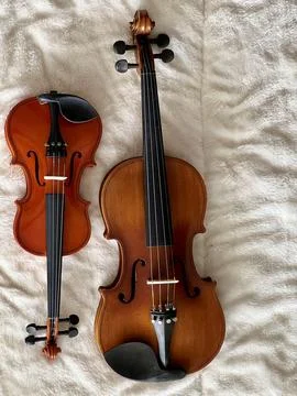 Two different size of violins put on soft cotton cloth, Stock Photos