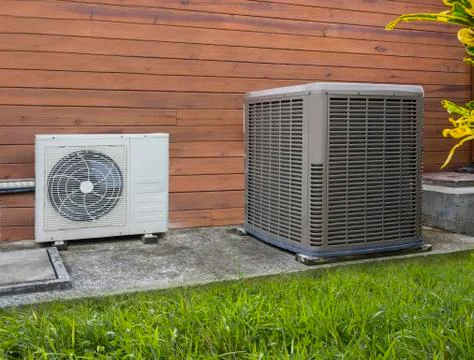 Two different sized air conditioning heat pumps Stock Photos
