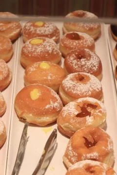 Two different sorts of donuts on a tray on a cruise ships buffet. Stock Photos
