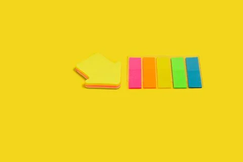 Two different sticky note blocks on a yellow surface Stock Photos