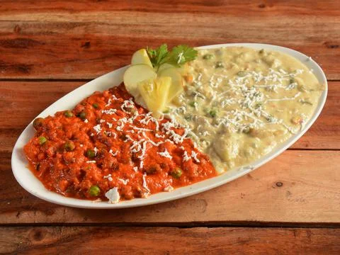 Two different types of Mattar curry made of Indian spices. served over a rust Stock Photos