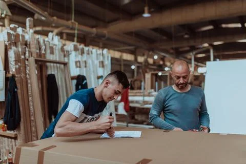 Two diligent workers collaboratively prepare the Stock Photos