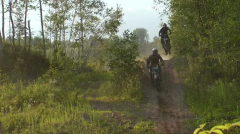 Two dirt bikes jump close together Stock Footage 52137072
