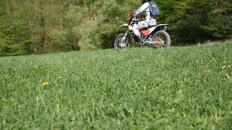 Two dirt motorcycles run through dusty road Stock Footage 107061109