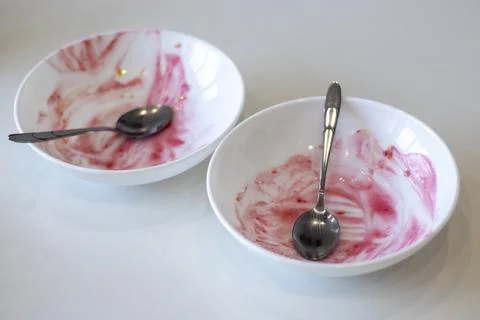 Two dirty empty plates after pink berries Stock Photos