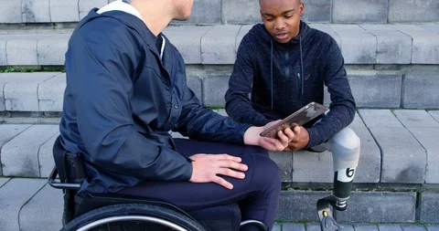 Two disabled athletics discussing over digital tablet 4k Video stock 96094440