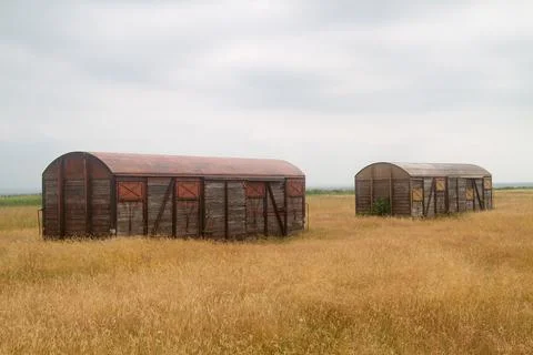 Two discarded train wagons in field Stock Photos