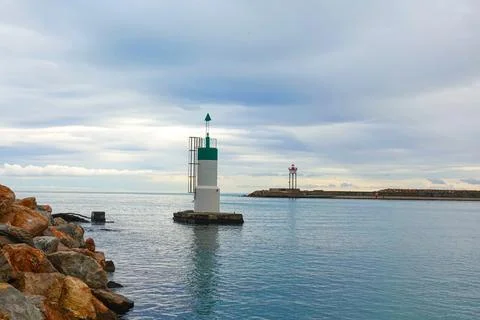 Two distinct lighthouse markers stand amidst tranquil waters, providing nav.. Stock Photos