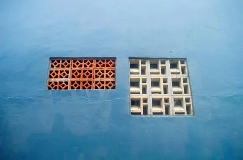 Two distinct ventilation blocks, one an orange geometric pattern and the ot.. Stock Photos