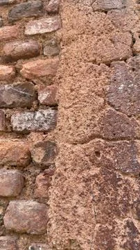Two Distinct Weathered Wall Textures Separated by an Uneven Vertical Seam Stockfoto's