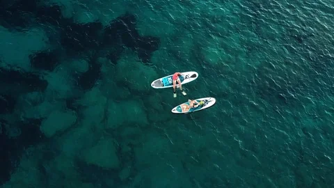 Two divers are preparing to dive to the reefs and the seabed. Clear and calm blu Stock Footage 107064841