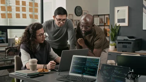 Two Diverse IT Specialists Looking at Laptop Screen, Coworker Explaining Task Stock Footage 329614708