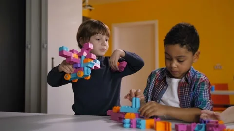 Two diverse kids arguing over toy in kindergarten Stock Footage 100048554