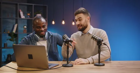 Two diverse people, podcast hosts, high-fiving in recording studio, online show Stock Footage 328973279