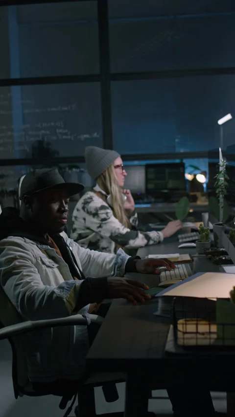 Two Diverse Programmers Working on Computer Code in Office at Night Stock Footage 273828957