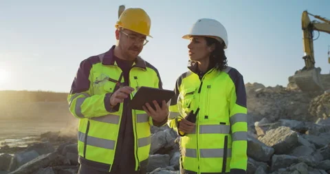 Two Diverse Workers Using Tablet On Construction Site Stock Footage 256042157