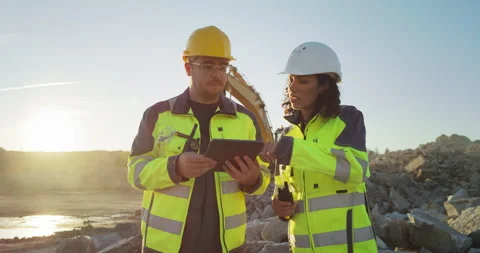 Two Diverse Workers Using Tablet On Construction Site Stock Footage 256042227