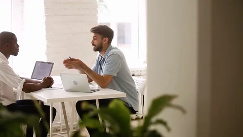 Two diverse young businessmen shaking hands after successful business Video stock 80705594