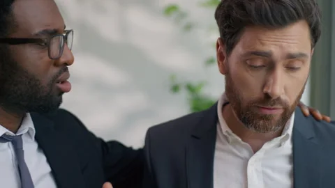 Two diversity multiethnic business men colleagues in office talking sad about Stock Footage 315498068