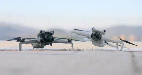 Two DJI Mini Drones On The Ground Ready For Takeoff Stock Footage 327296177
