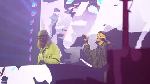 Two DJs performing on stage before a cheering concert crowd. Stock Footage 343239662