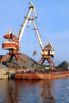 Two dock clamshell crane and barge Stock Photos