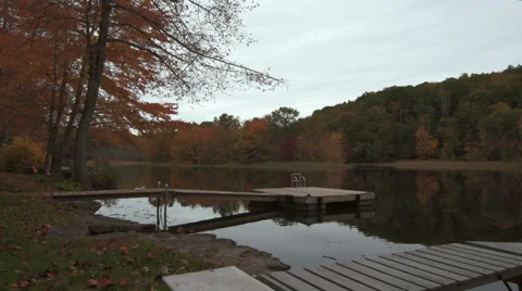 Two docks along a lakeshore during autumn Stock Footage 44115896